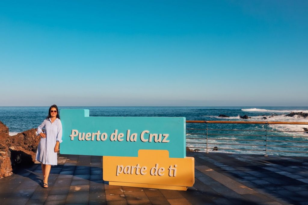 a sign of the city Puerto de la Cruz by the ocean 