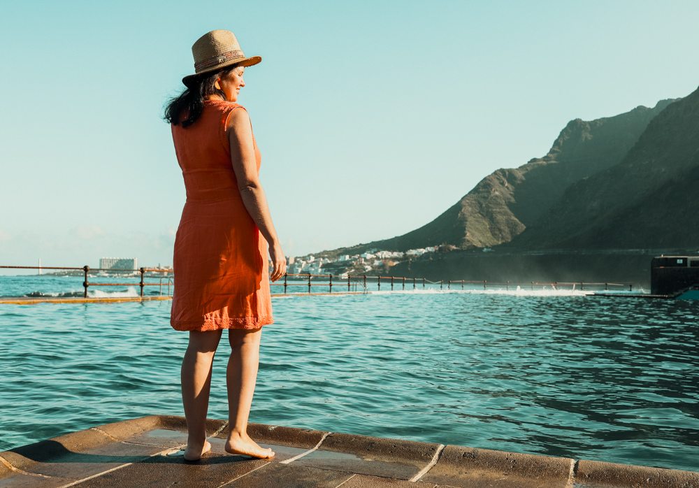 woman staying in front of the natural swimming pool in Tenerife