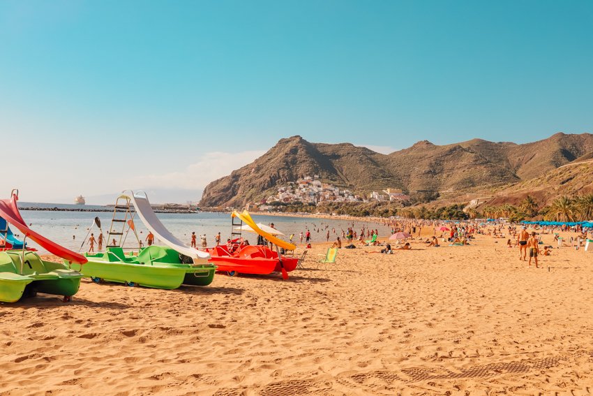 a beach, mountains and catamarans available for rent at Playa de las Teresitas 